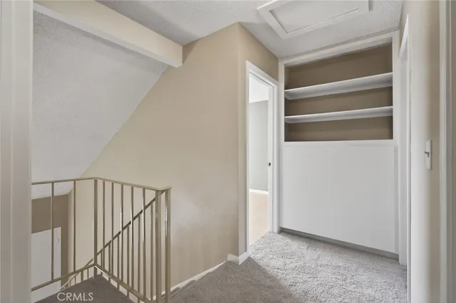 a view of a hallway with wooden floor and entryway
