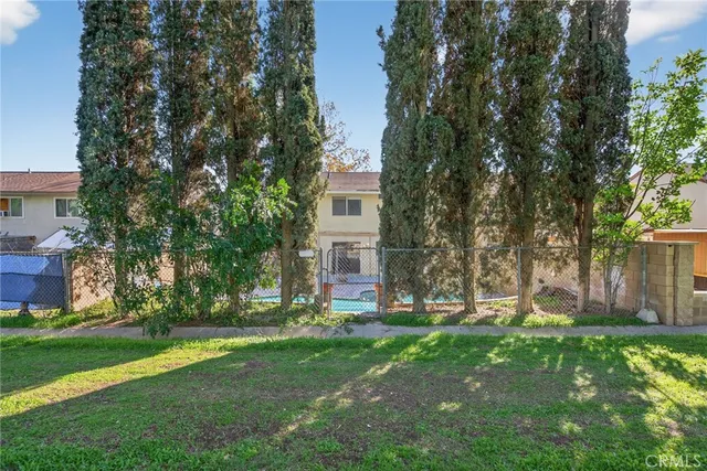 a view of a house with backyard and a tree