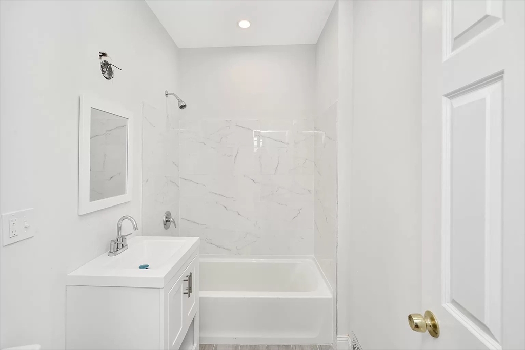 41 Dix Street, Unit 2 Boston, MA 02122 - Photo 13 of 19 a bathroom with a sink a bathtub and a shower