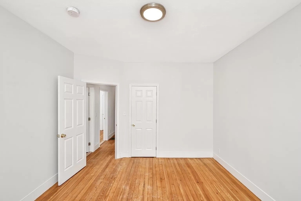 41 Dix Street, Unit 2 Boston, MA 02122 - Photo 18 of 19 a view of a room with wooden floor and white walls