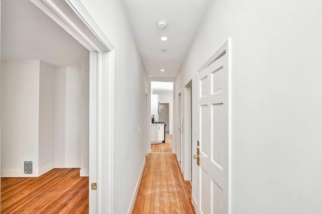 41 Dix Street, Unit 2 Boston, MA 02122 - Photo 5 of 19 a view of a hallway with wooden floor and closet