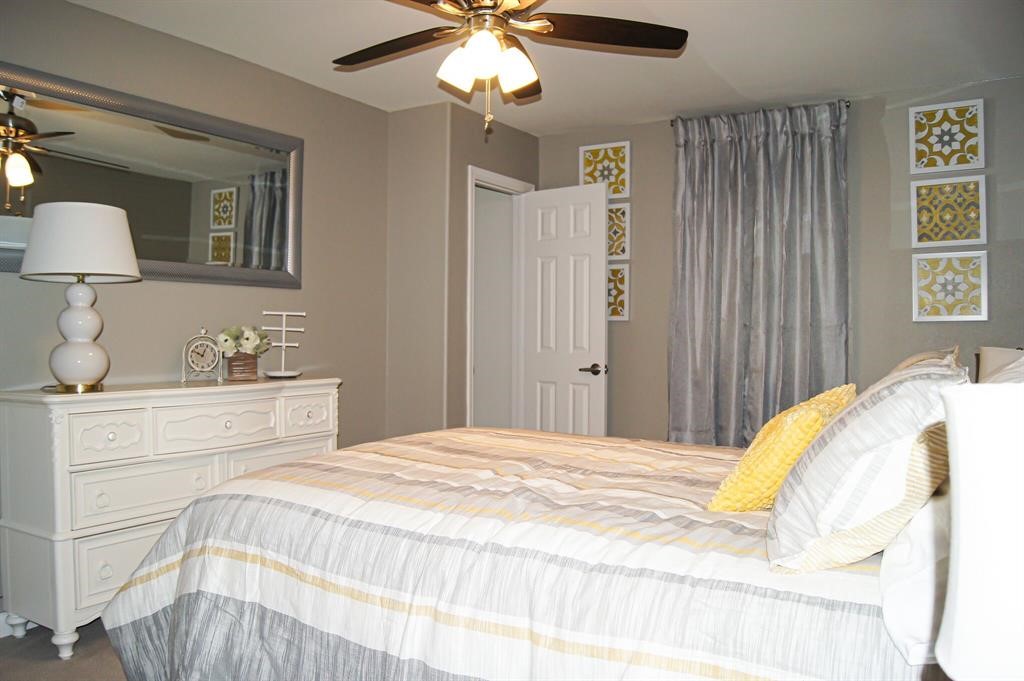 1727 Pueblo Street Dallas, TX 75212 - Photo 15 of 27 a bedroom with a bed and a chandelier