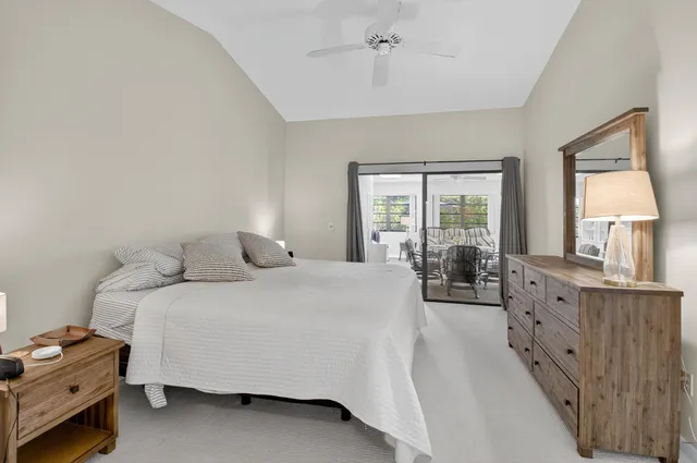 a bedroom with a bed and large windows