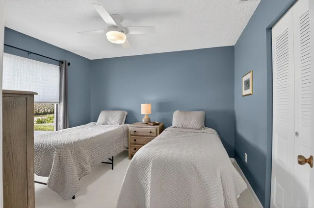 a bedroom with two beds and a lamp