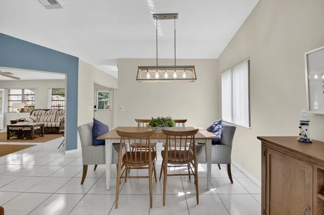 a view of a dining room with furniture and chandelier