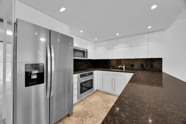 a bathroom with a granite countertop sink a toilet and a shower