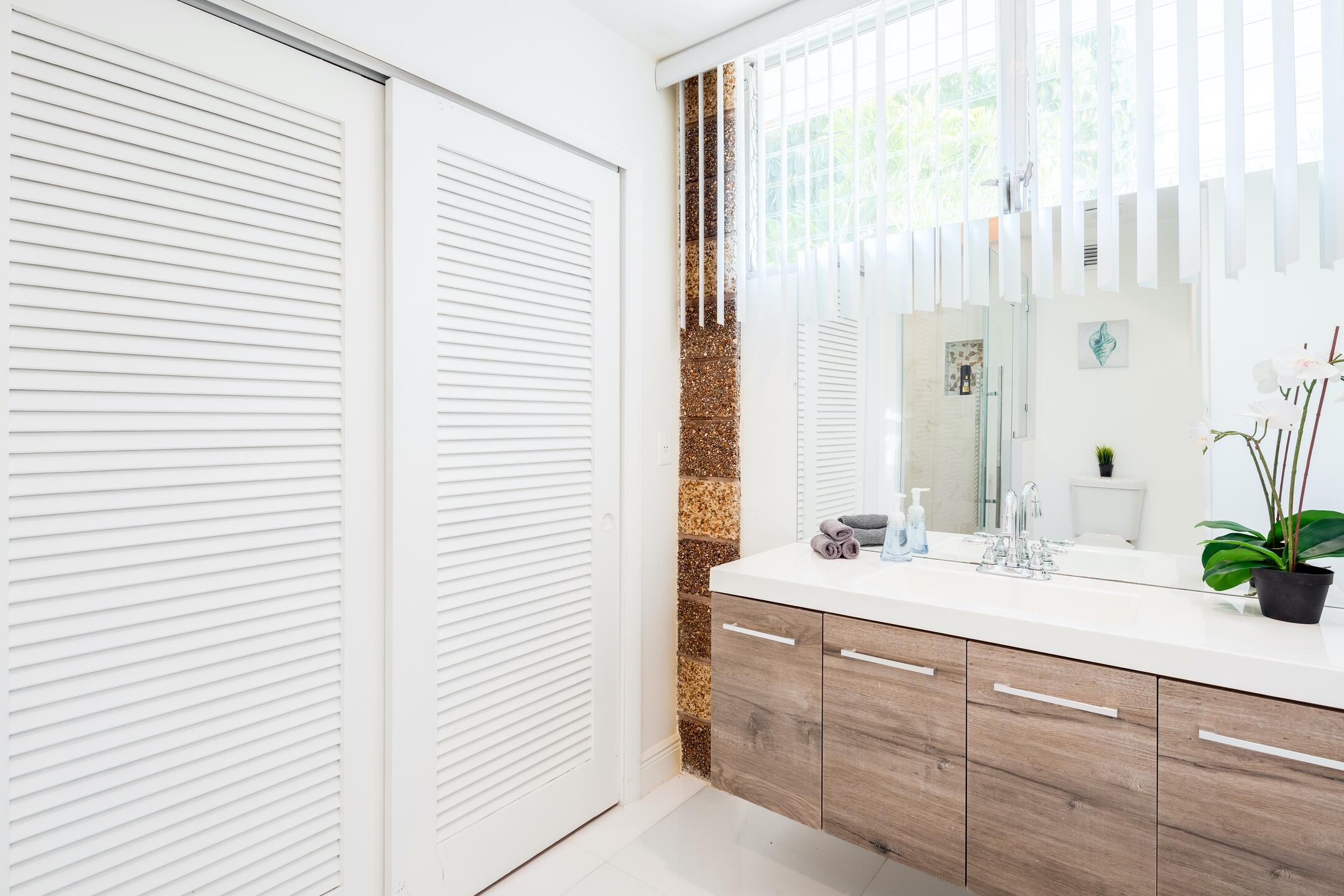 7306 Clarke Road Lake Clarke Shores, FL 33406 - Photo 13 of 36 a bathroom with a double vanity sink and a mirror
