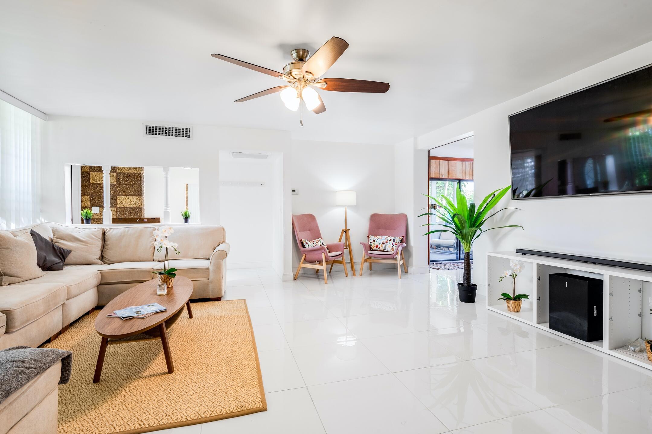 7306 Clarke Road Lake Clarke Shores, FL 33406 - Photo 17 of 36 a living room with furniture a fireplace and a flat screen tv
