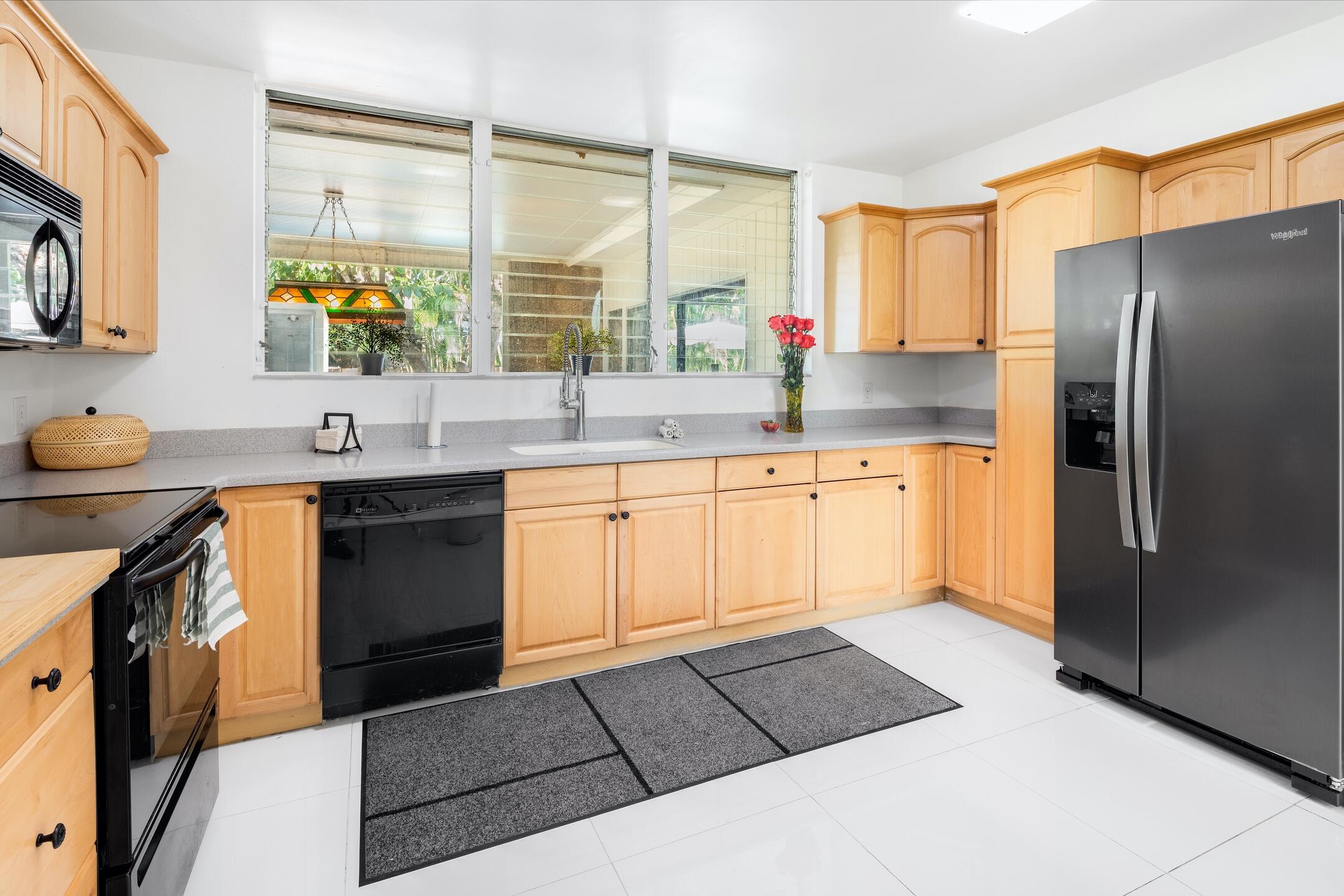 7306 Clarke Road Lake Clarke Shores, FL 33406 - Photo 20 of 36 a kitchen with a sink refrigerator and cabinets