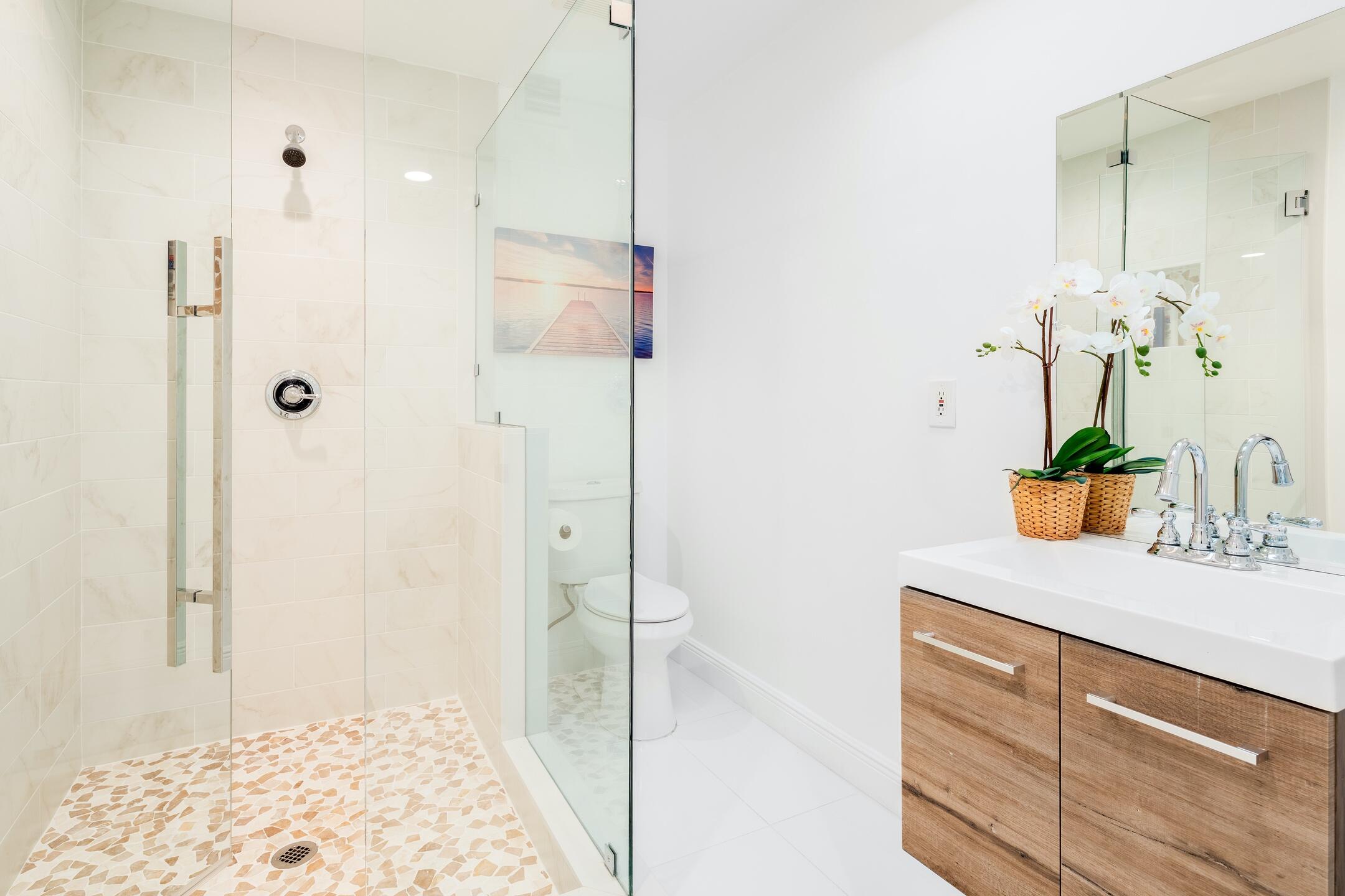 7306 Clarke Road Lake Clarke Shores, FL 33406 - Photo 25 of 36 a bathroom with a shower sink and a mirror