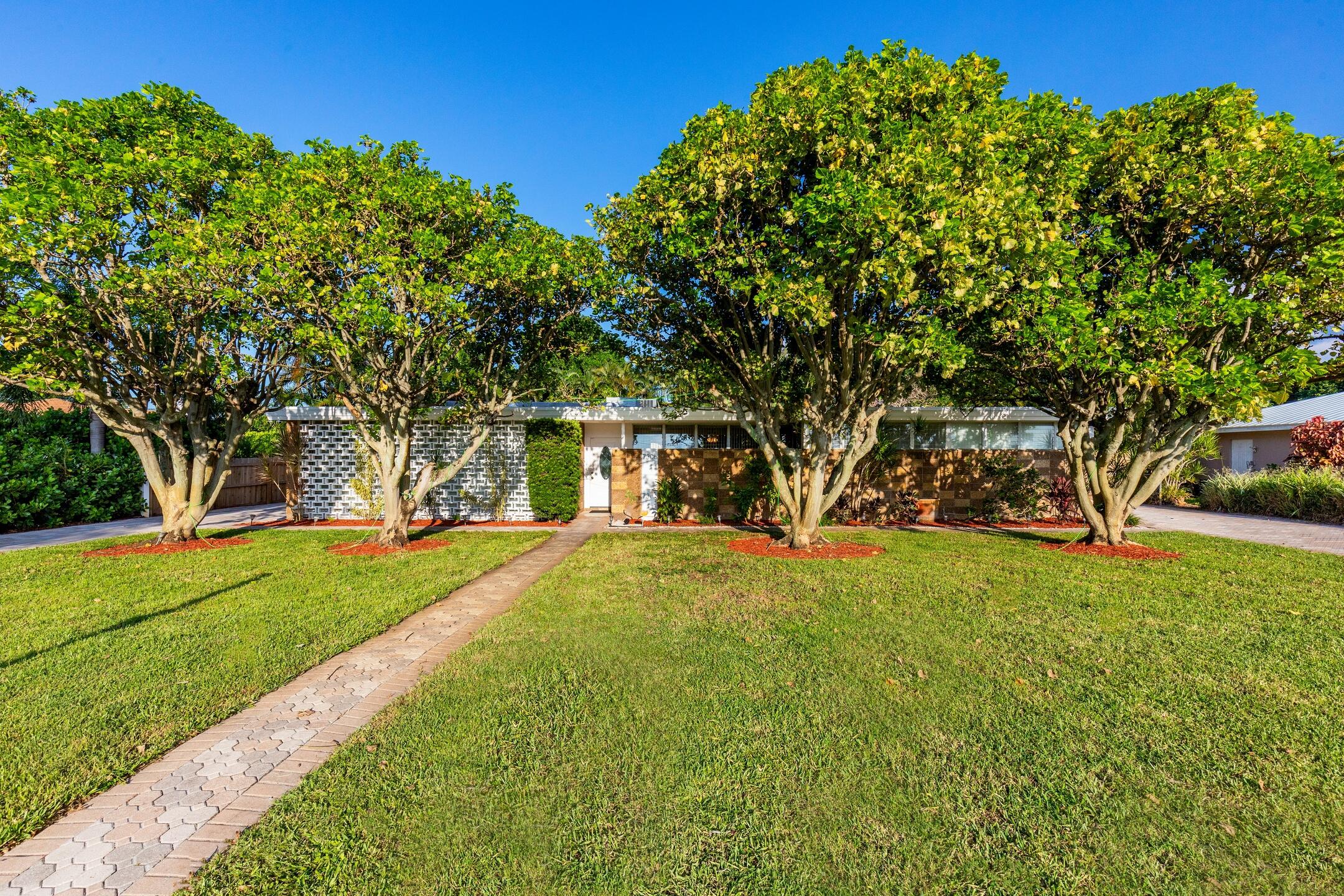 7306 Clarke Road Lake Clarke Shores, FL 33406 - Photo 27 of 36 a view of a yard with plants and trees