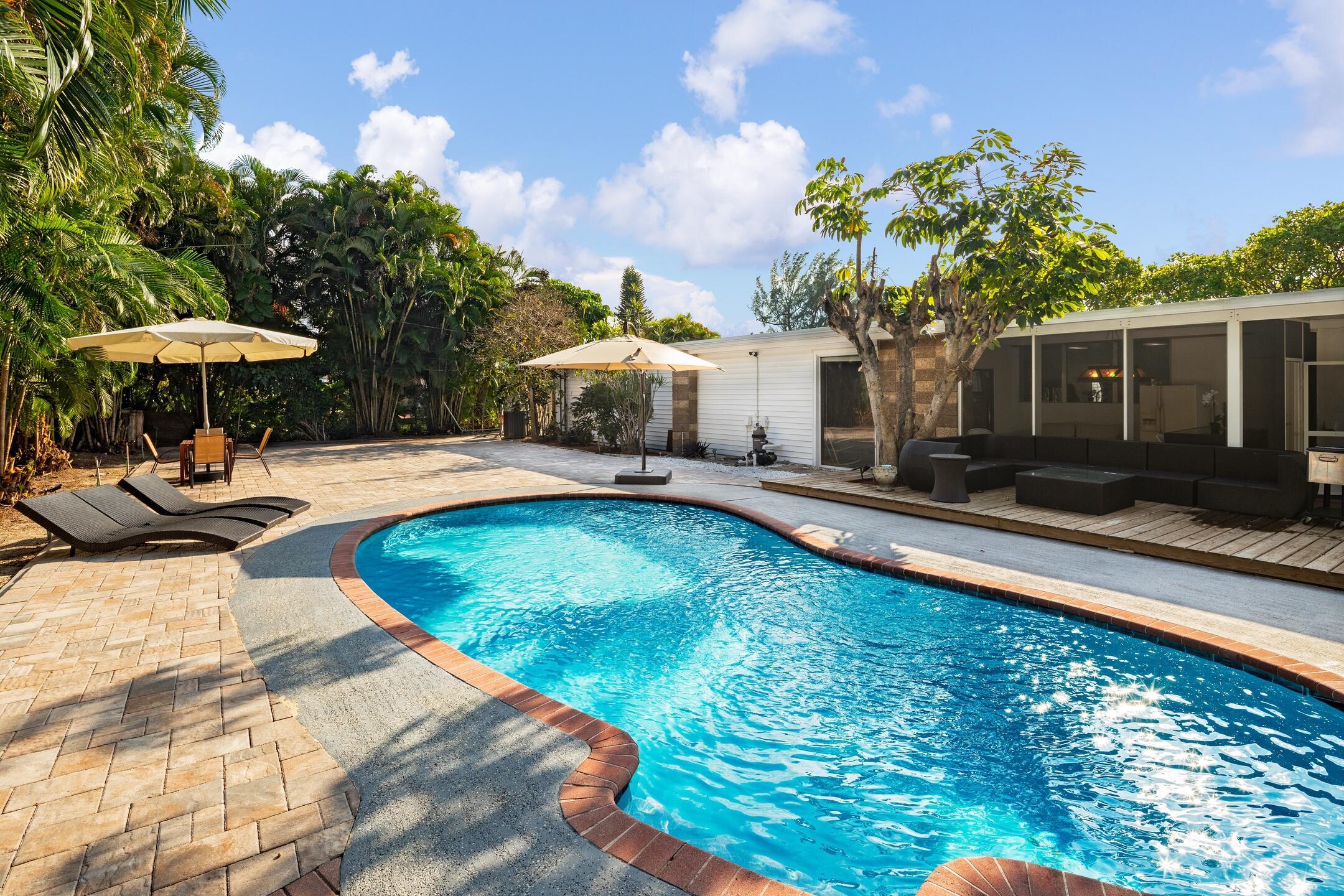 7306 Clarke Road Lake Clarke Shores, FL 33406 - Photo 3 of 36 a swimming pool with outdoor seating yard and barbeque oven