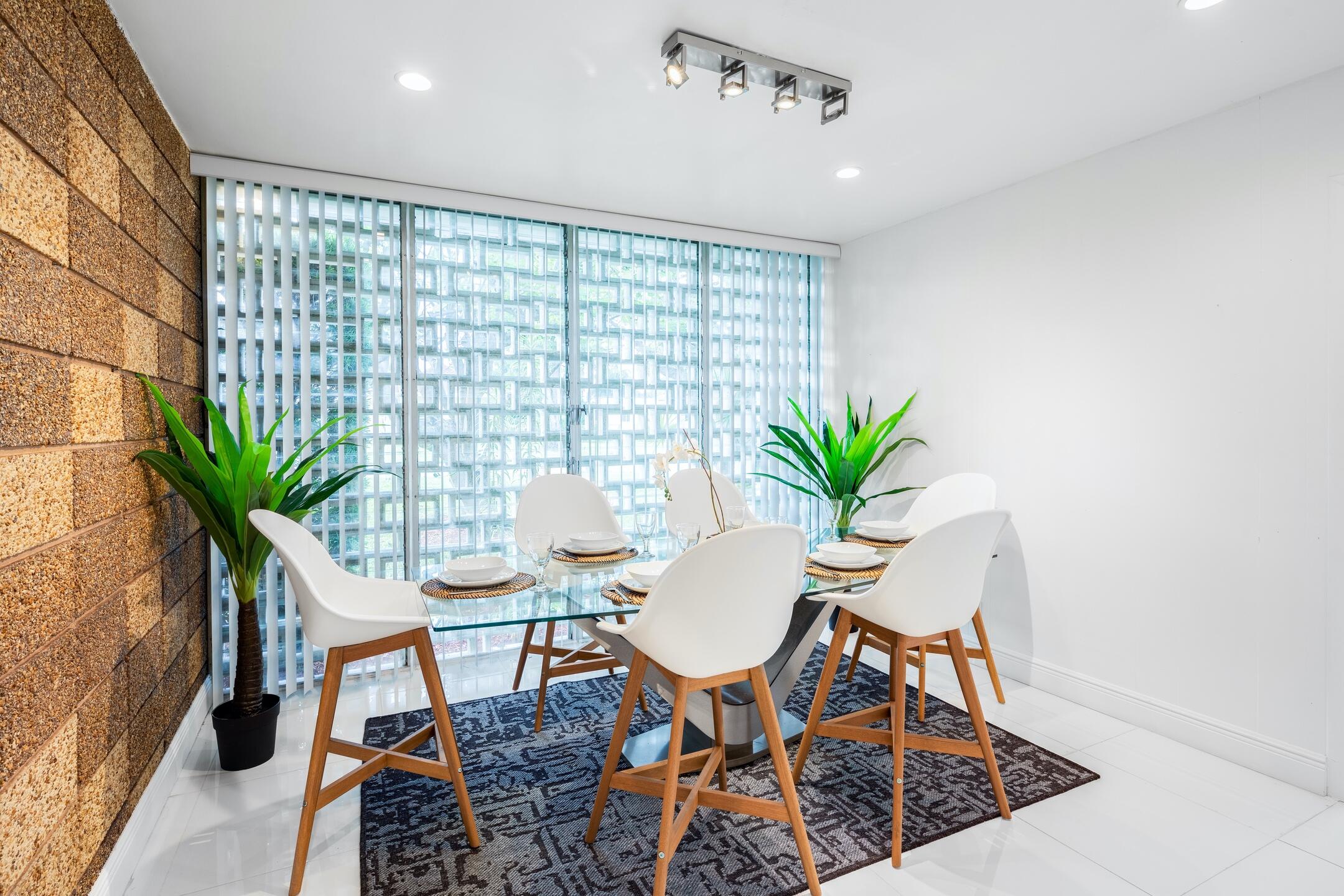 7306 Clarke Road Lake Clarke Shores, FL 33406 - Photo 31 of 36 a view of a dining room with furniture and a potted plant