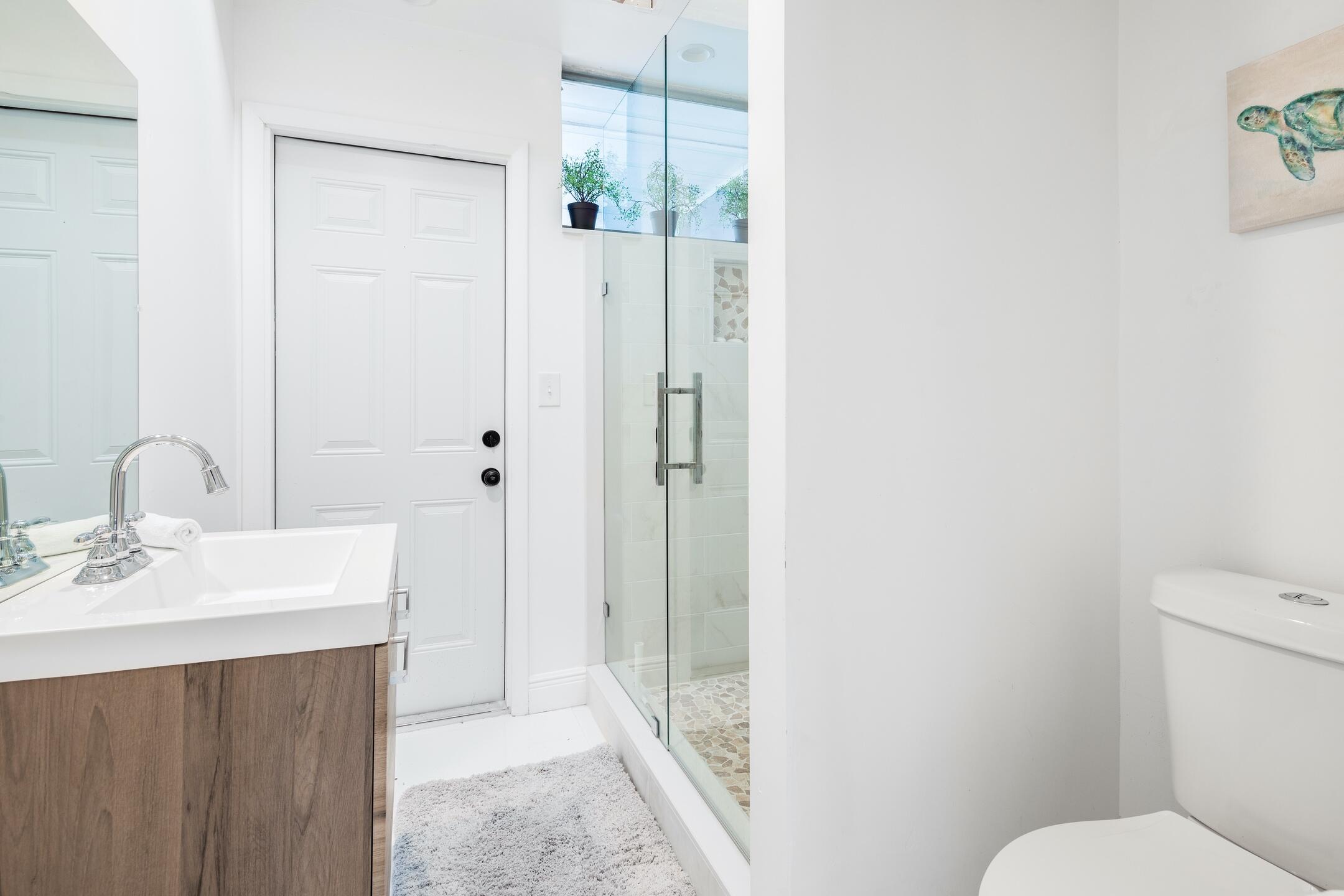 7306 Clarke Road Lake Clarke Shores, FL 33406 - Photo 33 of 36 a bathroom with a sink a toilet and shower