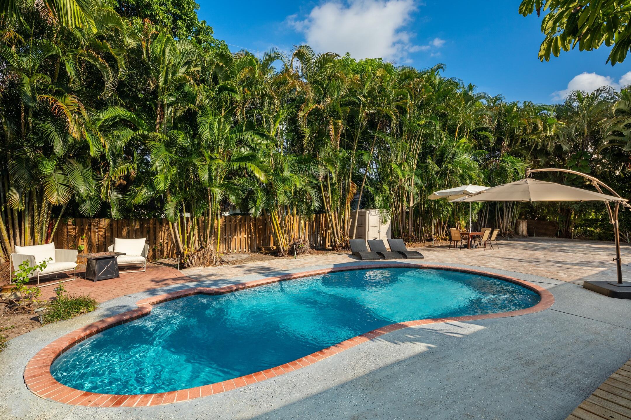 7306 Clarke Road Lake Clarke Shores, FL 33406 - Photo 4 of 36 a view of a swimming pool with a patio