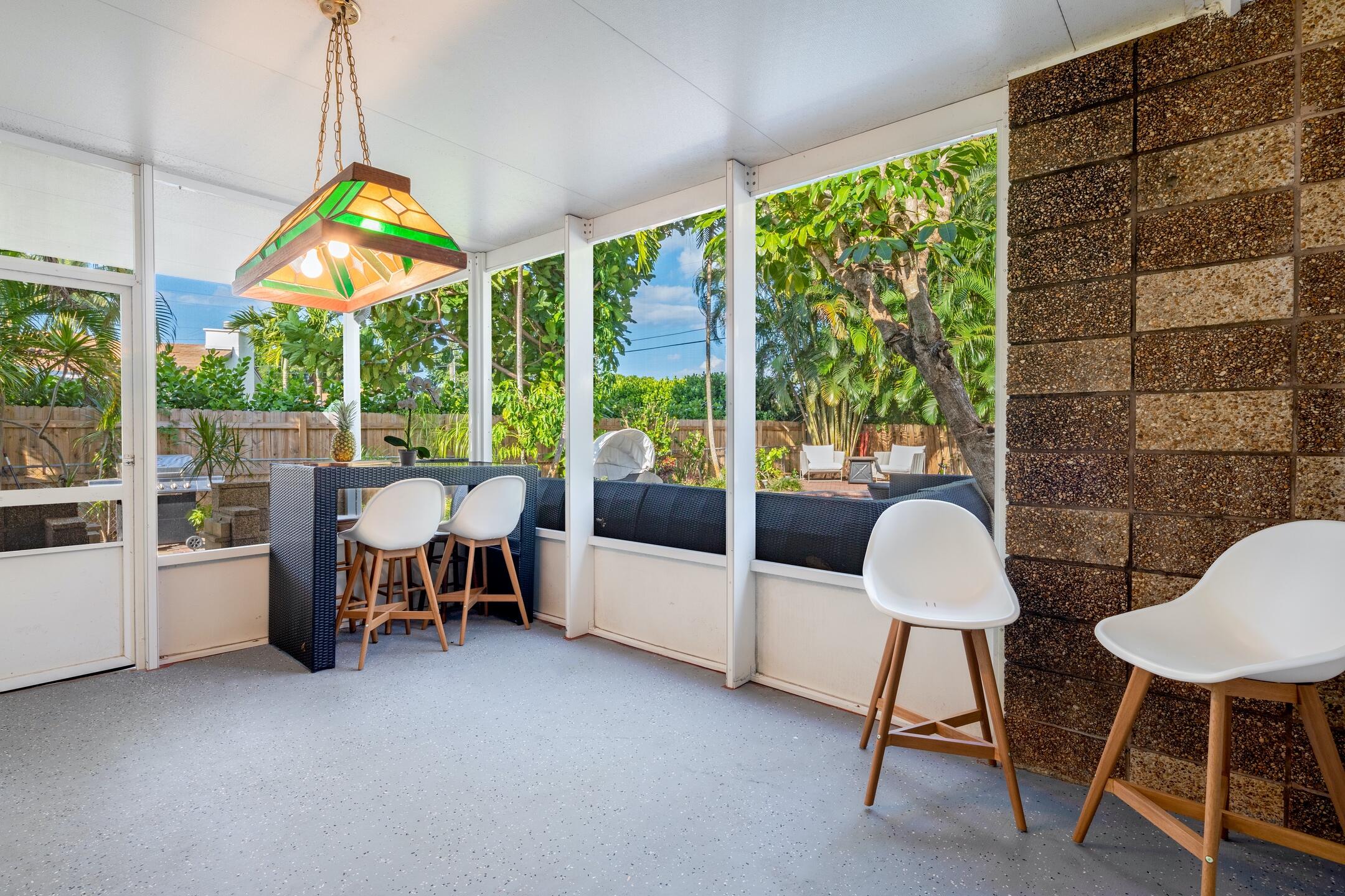 7306 Clarke Road Lake Clarke Shores, FL 33406 - Photo 7 of 36 a living room with furniture and a floor to ceiling window