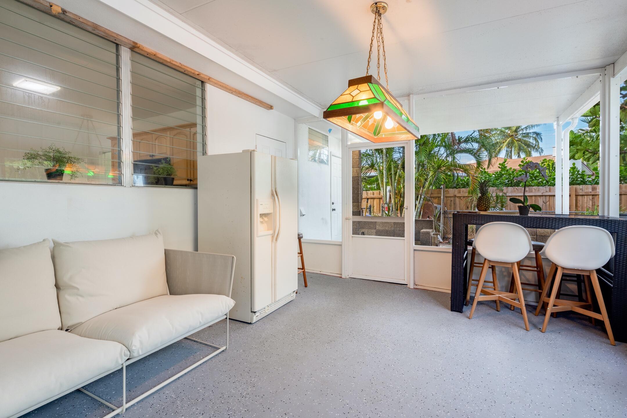 7306 Clarke Road Lake Clarke Shores, FL 33406 - Photo 8 of 36 a living room with furniture and a chandelier