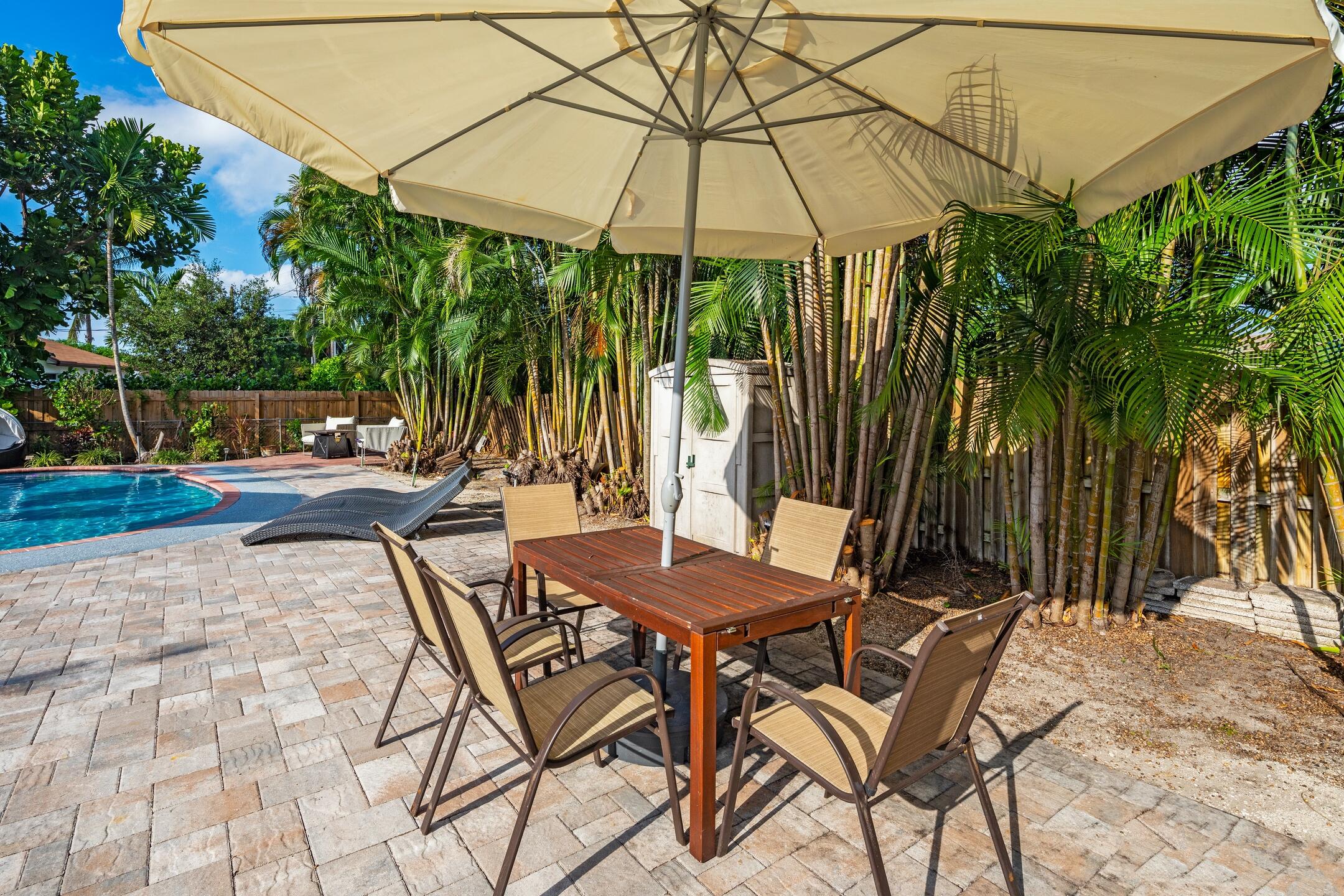 7306 Clarke Road Lake Clarke Shores, FL 33406 - Photo 10 of 36 a view of a backyard with a patio and wooden floor