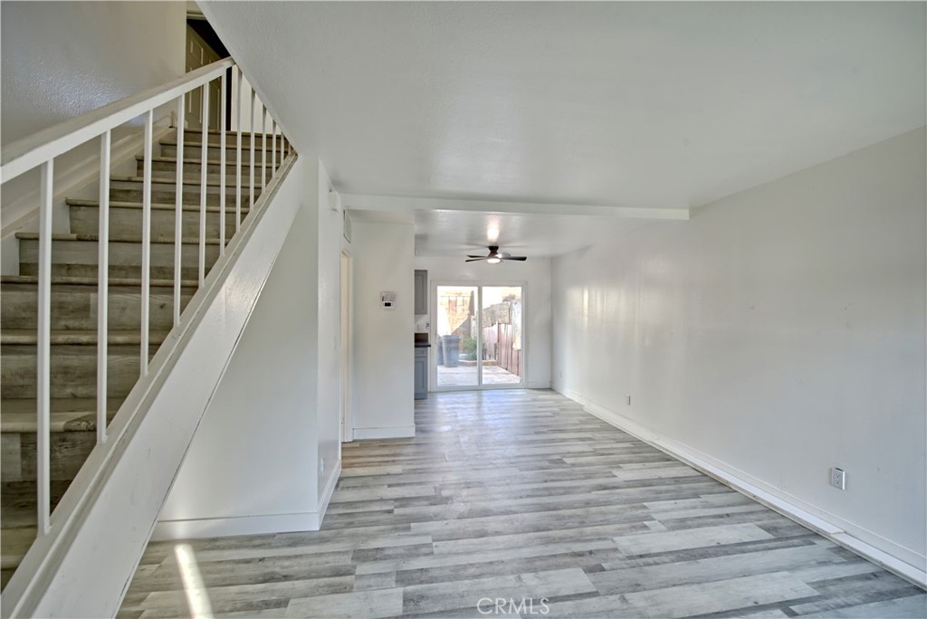 474 West Jackson Street Rialto, CA 92376 - Photo 2 of 14 a view of a hallway with wooden floor and staircase