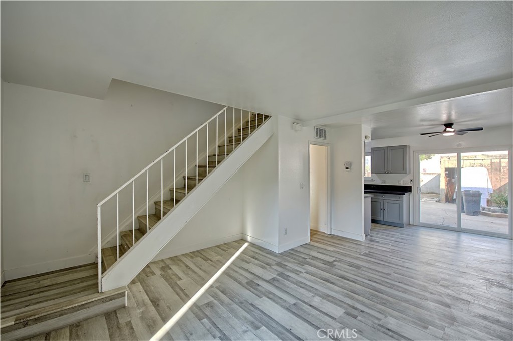 474 West Jackson Street Rialto, CA 92376 - Photo 3 of 14 a view of a livingroom with wooden floor staircase and a kitchen