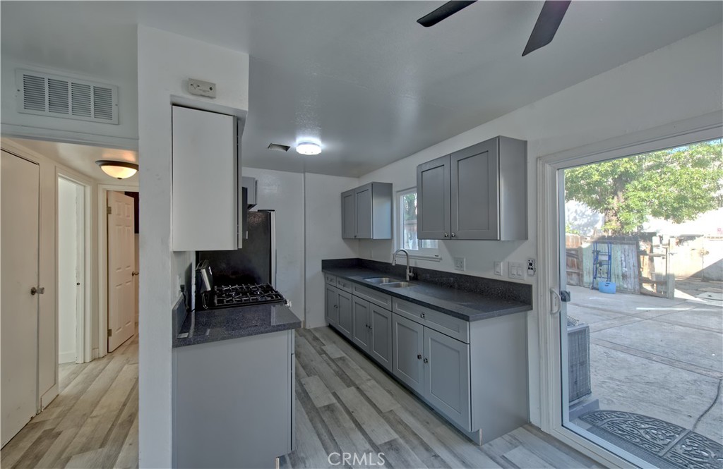 474 West Jackson Street Rialto, CA 92376 - Photo 6 of 14 a kitchen with stainless steel appliances granite countertop a sink stove and refrigerator