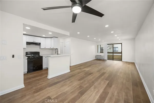 a view of kitchen with refrigerator sink and stove