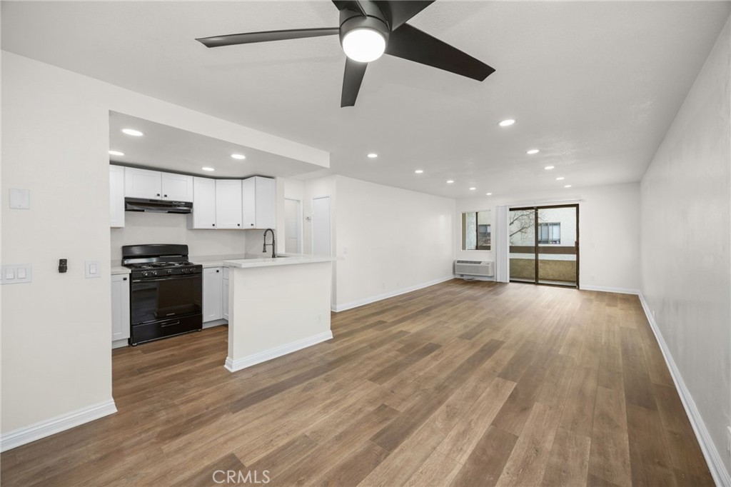 a view of kitchen with refrigerator sink and stove