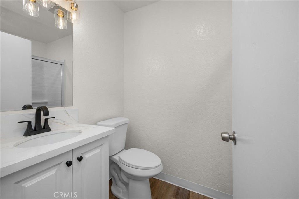 600 West 3rd Street, Unit B205 Santa Ana, CA 92701 - Photo 19 of 34 a bathroom with a sink a toilet and mirror