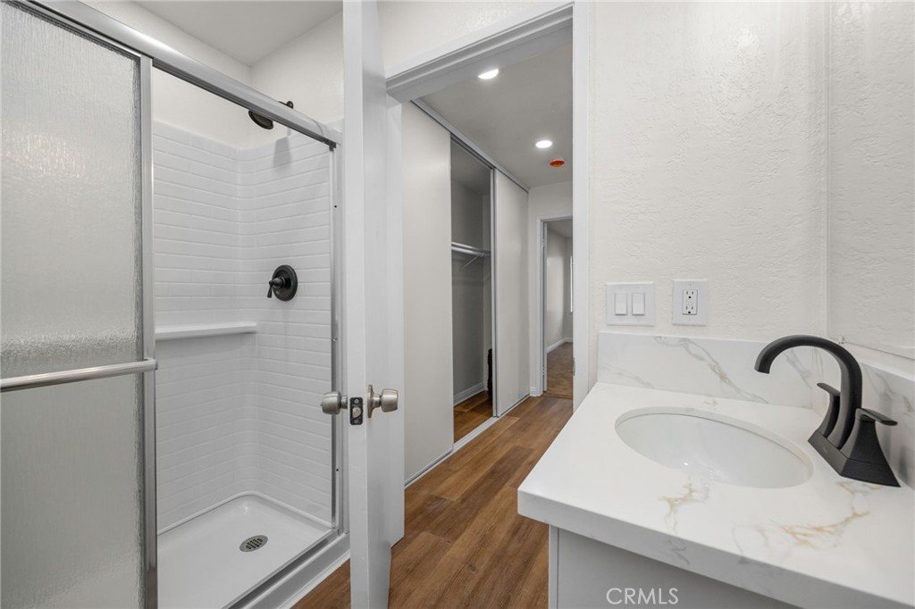 600 West 3rd Street, Unit B205 Santa Ana, CA 92701 - Photo 20 of 34 a bathroom with a sink shower and a mirror