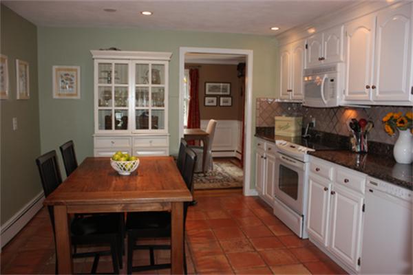 5 Ward Road Sudbury, MA 01776 - Photo 9 of 25 a kitchen with stainless steel appliances granite countertop a stove top oven a sink a dining table and chairs