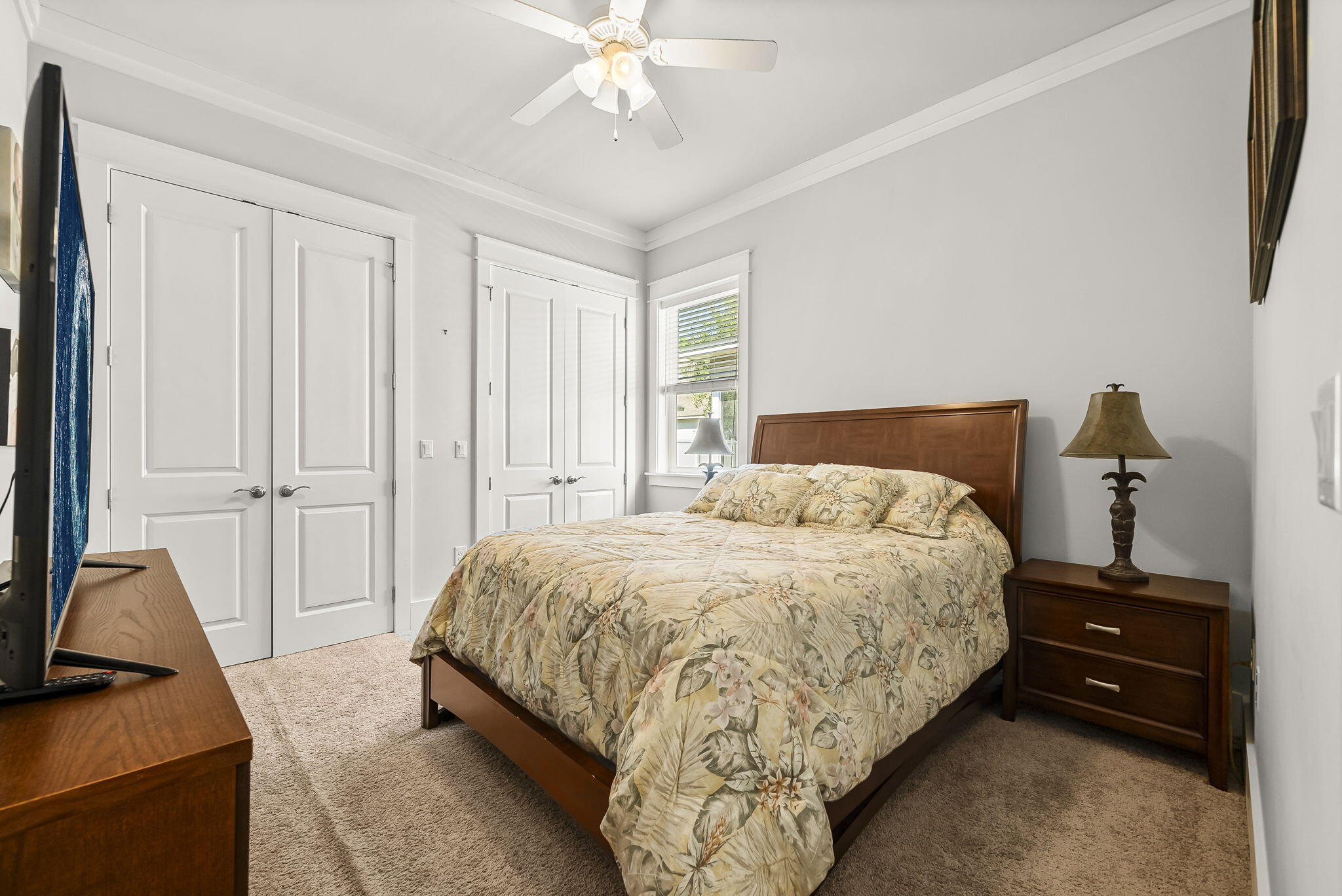 209 Blakely Drew Boulevard Santa Rosa Beach, FL 32459 - Photo 23 of 45 a bedroom with a bed and a flat tv screen on dresser