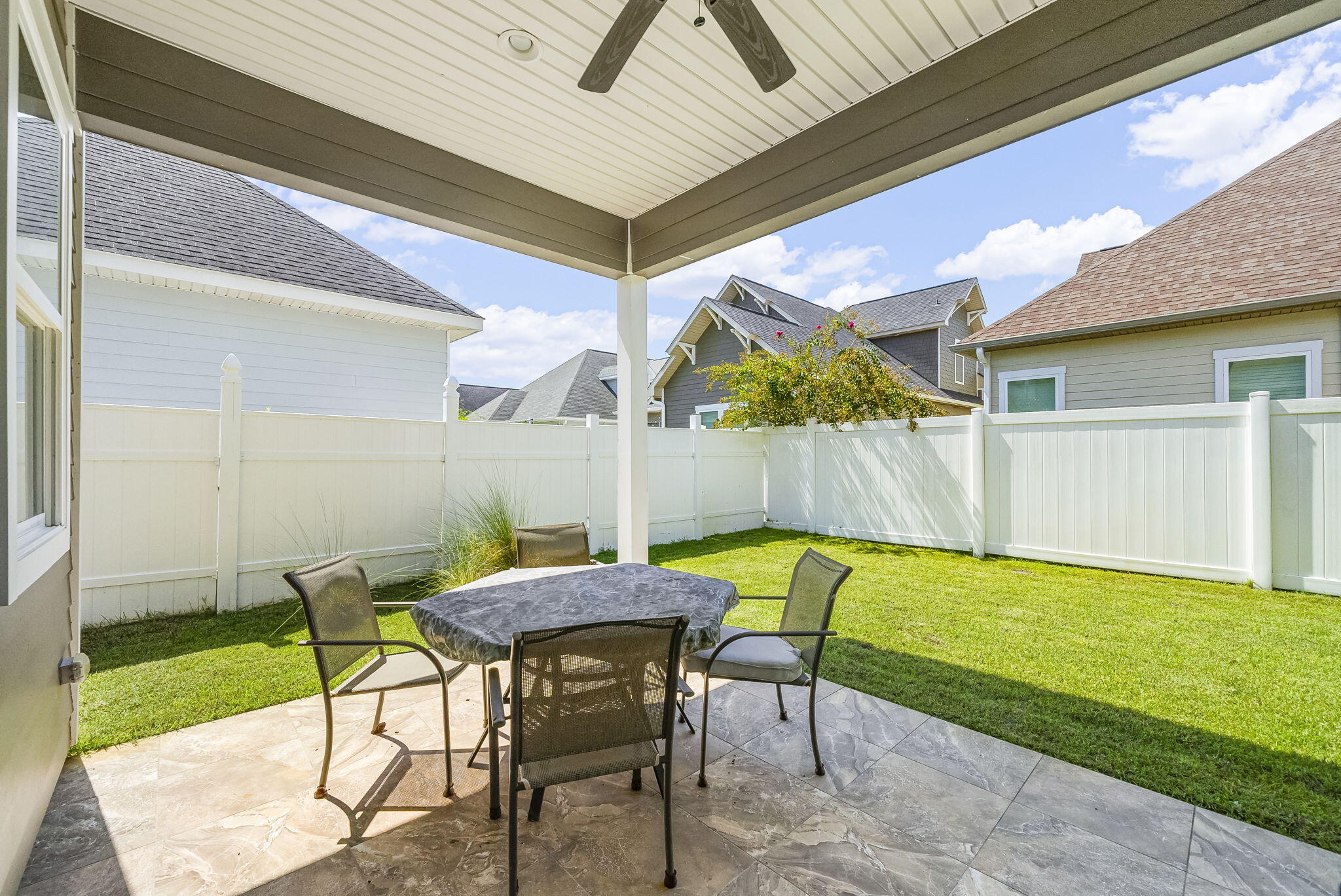 209 Blakely Drew Boulevard Santa Rosa Beach, FL 32459 - Photo 31 of 45 a view of a patio with table and chairs with wooden floor and a yard