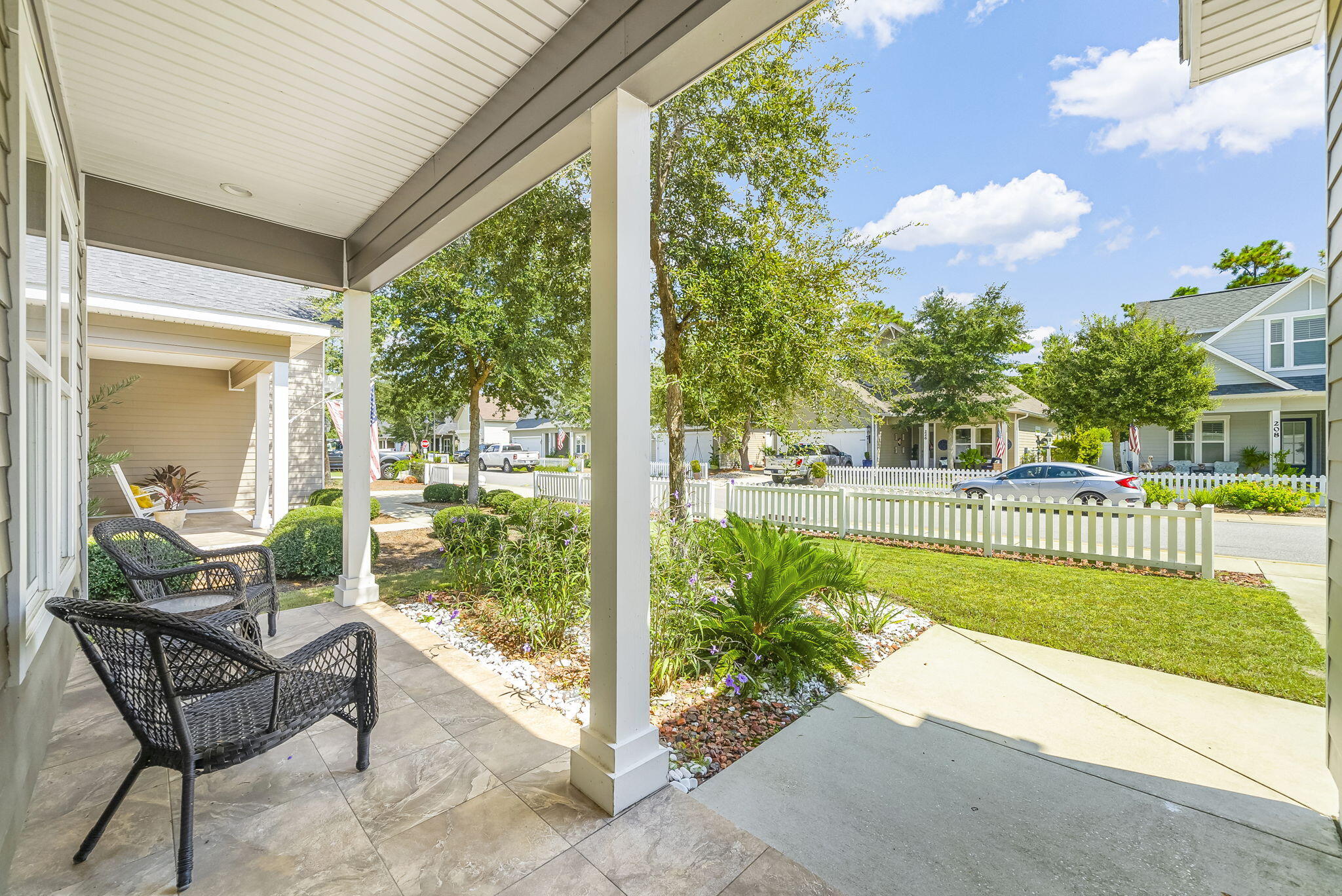 209 Blakely Drew Boulevard Santa Rosa Beach, FL 32459 - Photo 5 of 45 a view of a porch with chairs and plants