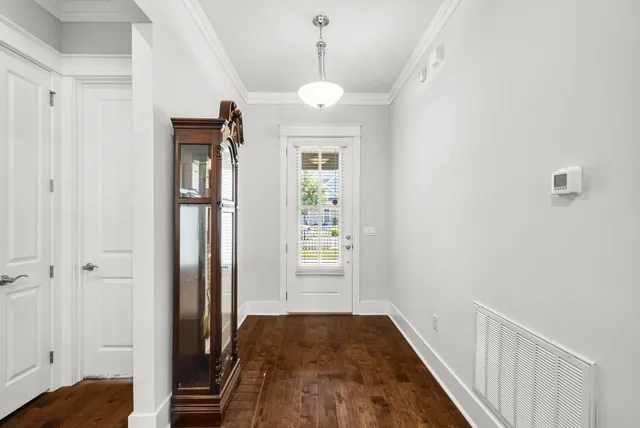 a view of a hallway view with wooden floor and staircase