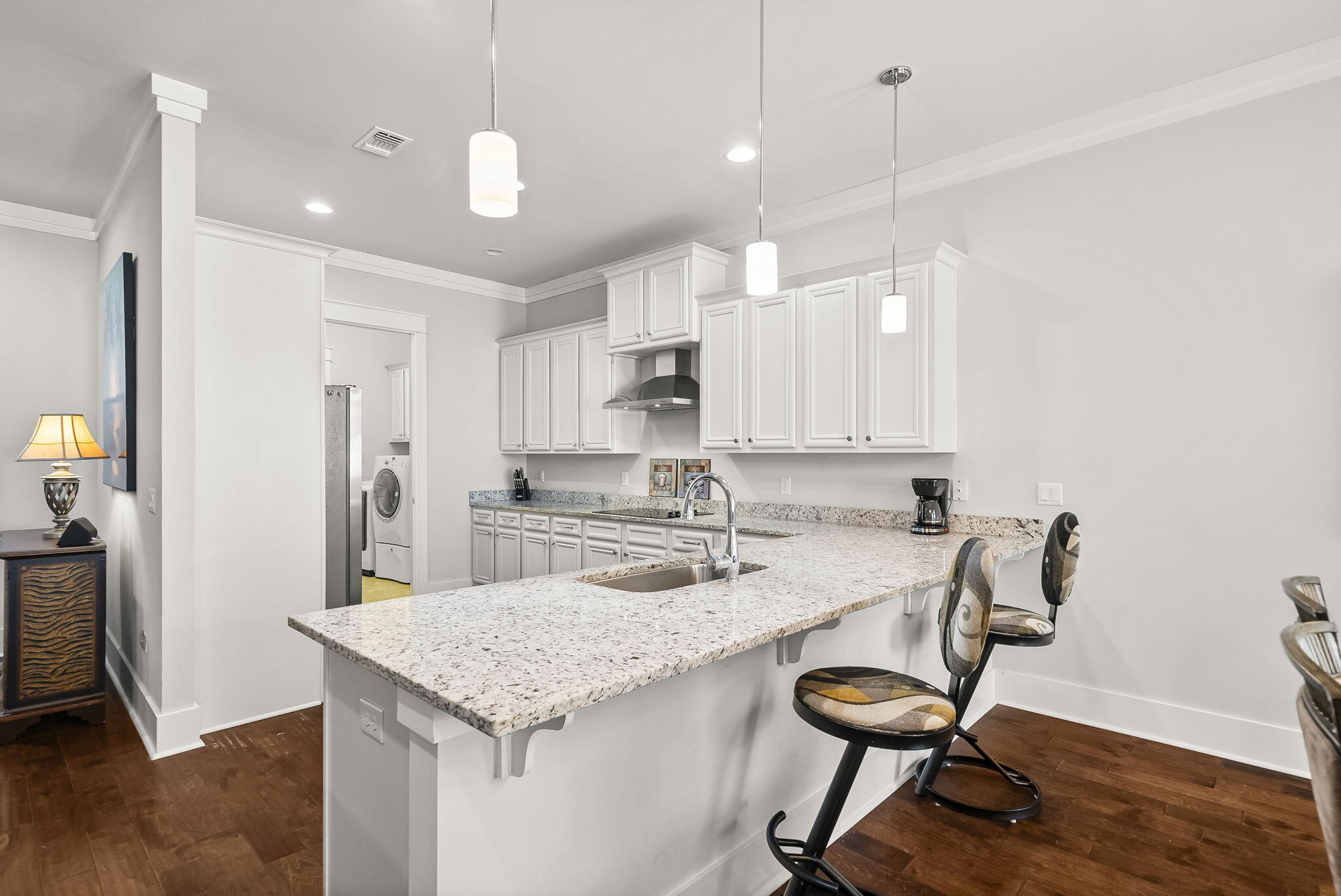 209 Blakely Drew Boulevard Santa Rosa Beach, FL 32459 - Photo 9 of 45 a kitchen with kitchen island a table and chairs in it