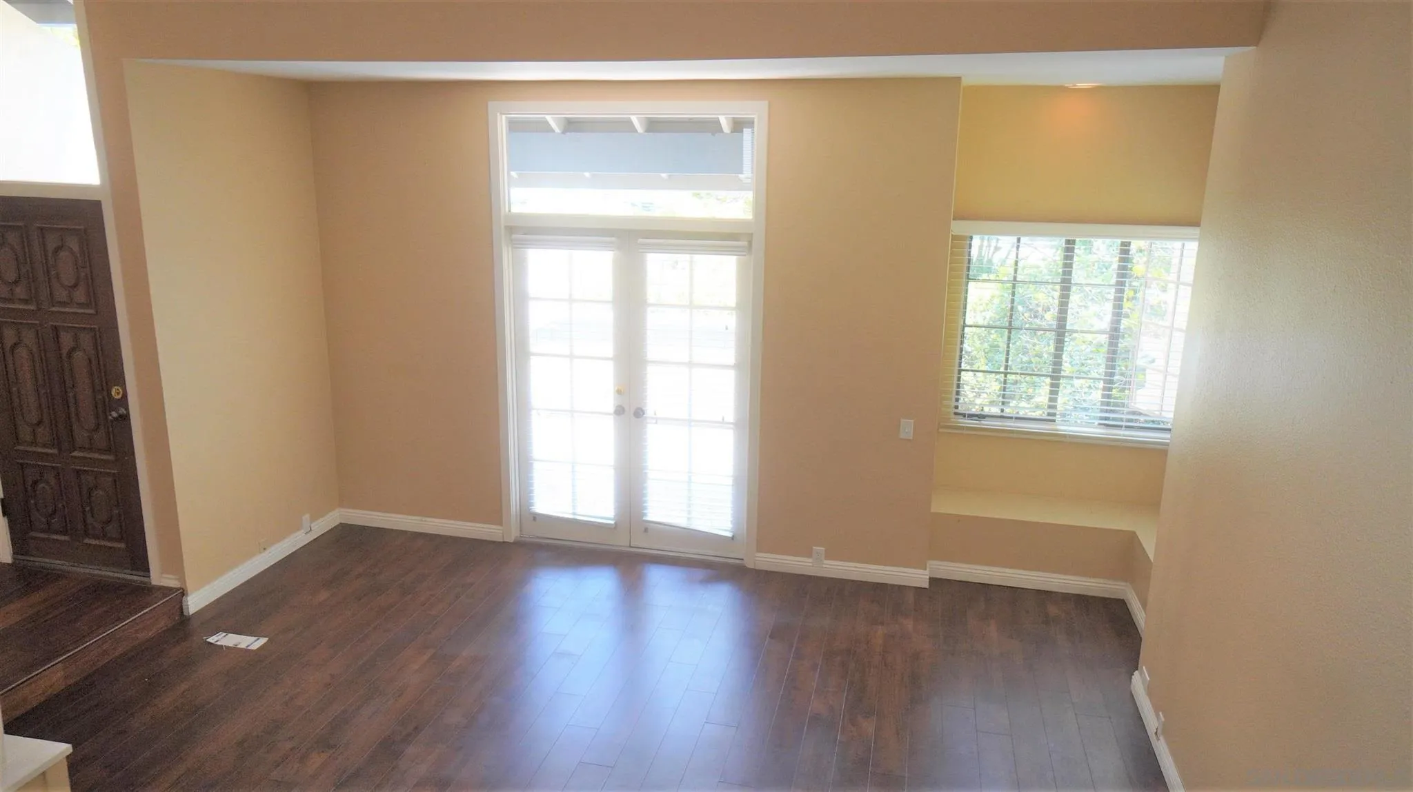 3195 Morning Way La Jolla, CA 92037 - Photo 7 of 18 an empty room with wooden floor and windows