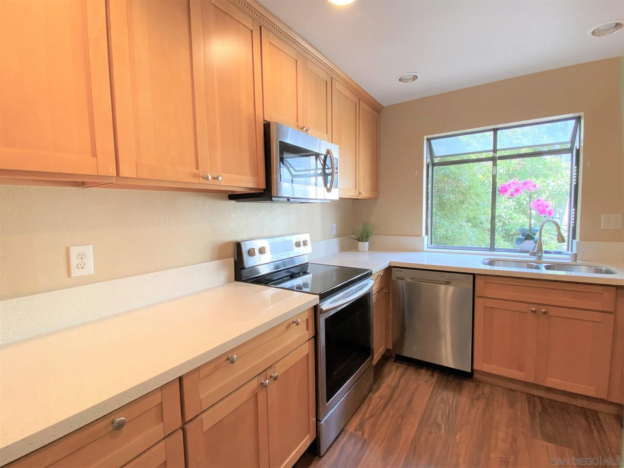 3195 Morning Way La Jolla, CA 92037 - Photo 9 of 18 a kitchen with stainless steel appliances granite countertop a sink cabinets and wooden floor
