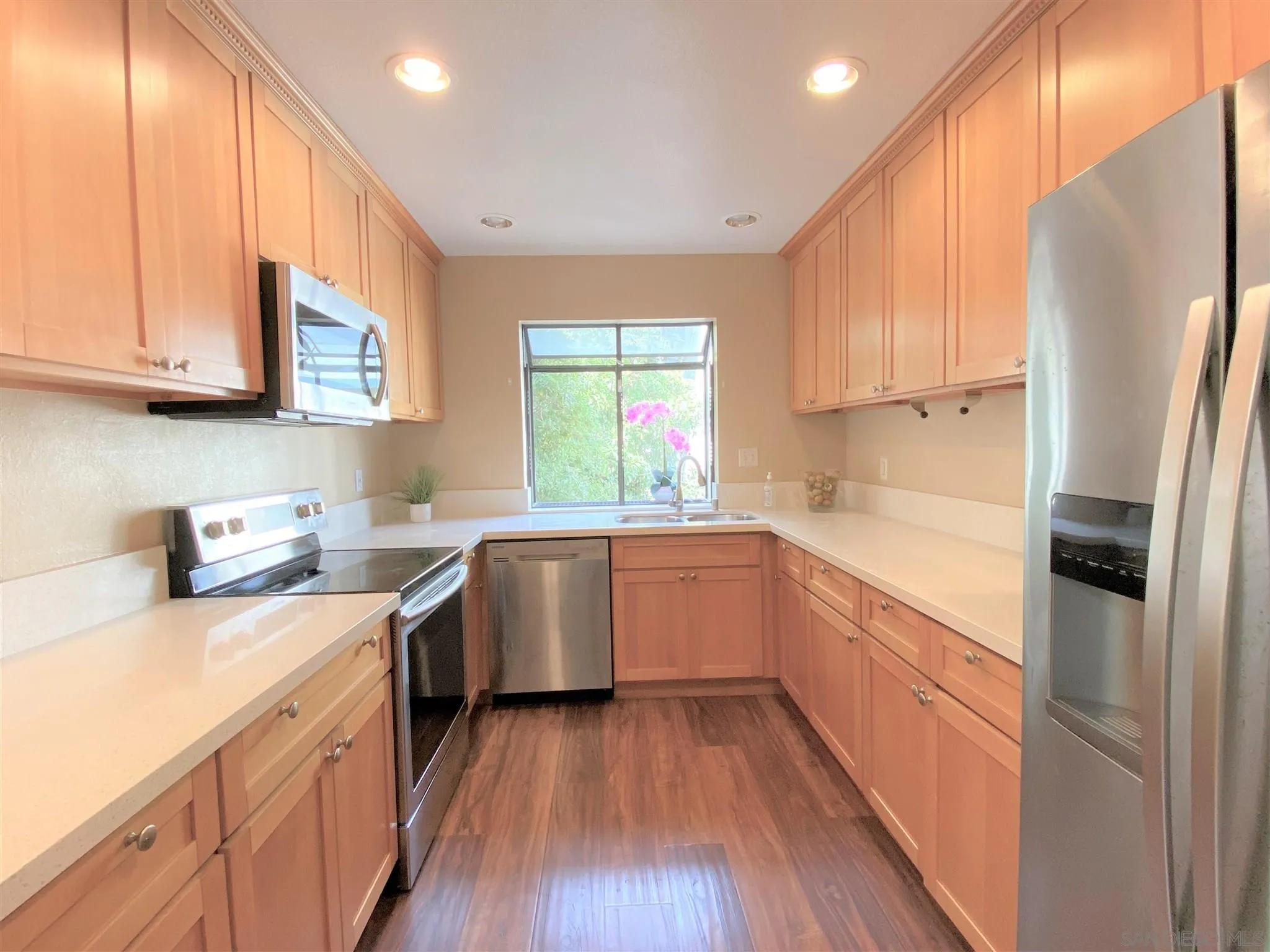 3195 Morning Way La Jolla, CA 92037 - Photo 10 of 18 a kitchen with a sink a refrigerator a stove a microwave and cabinets