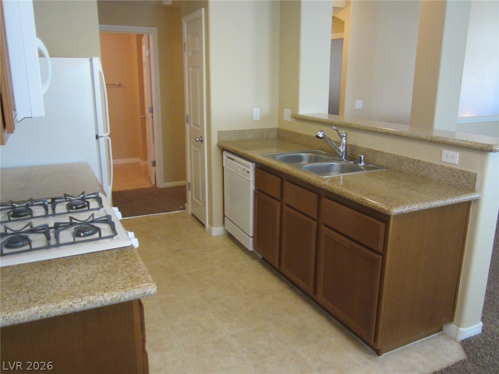 7701 West Robindale Road, Unit 262 Las Vegas, NV 89113 - Photo 12 of 26 Functional kitchen with ample counter space and integrated appliances for convenient meal preparation.