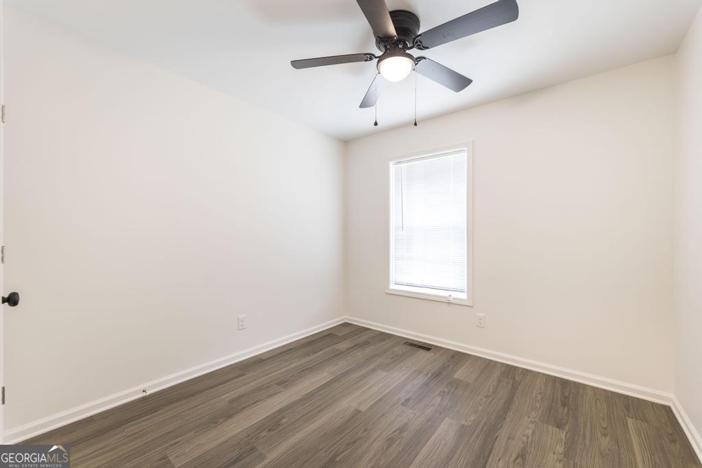 180 Ward Street Macon, GA 31204 - Photo 16 of 26 an empty room with wooden floor ceiling fan and window