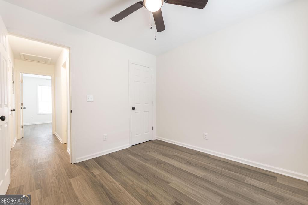 180 Ward Street Macon, GA 31204 - Photo 17 of 26 a view of a room with wooden floor a ceiling fan