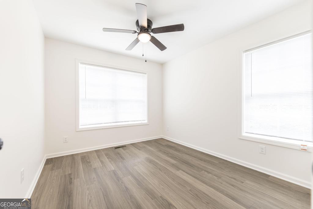 180 Ward Street Macon, GA 31204 - Photo 19 of 26 an empty room with a window and a ceiling fan