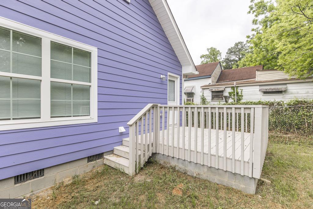 180 Ward Street Macon, GA 31204 - Photo 22 of 26 a view of a house with a small yard and wooden fence