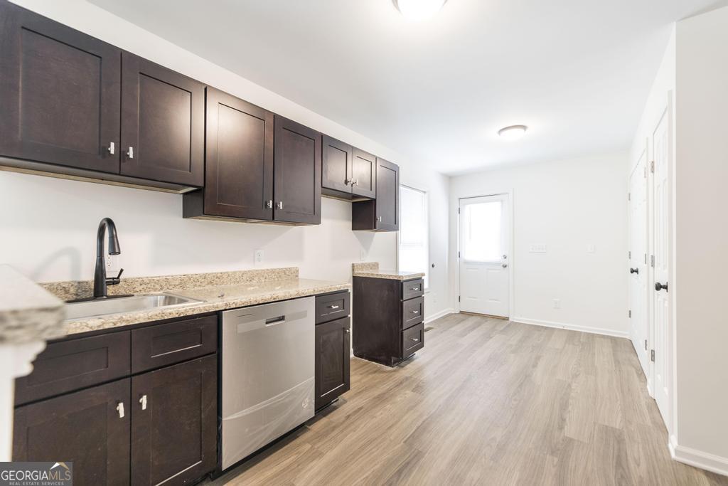 180 Ward Street Macon, GA 31204 - Photo 8 of 26 a kitchen with granite countertop wooden cabinets a sink and dishwasher