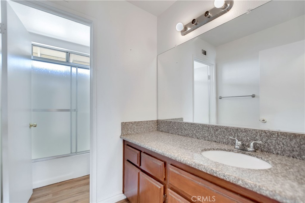 14527 Pony Trail Road Victorville, CA 92392 - Photo 8 of 21 a bathroom with a granite countertop sink and a mirror