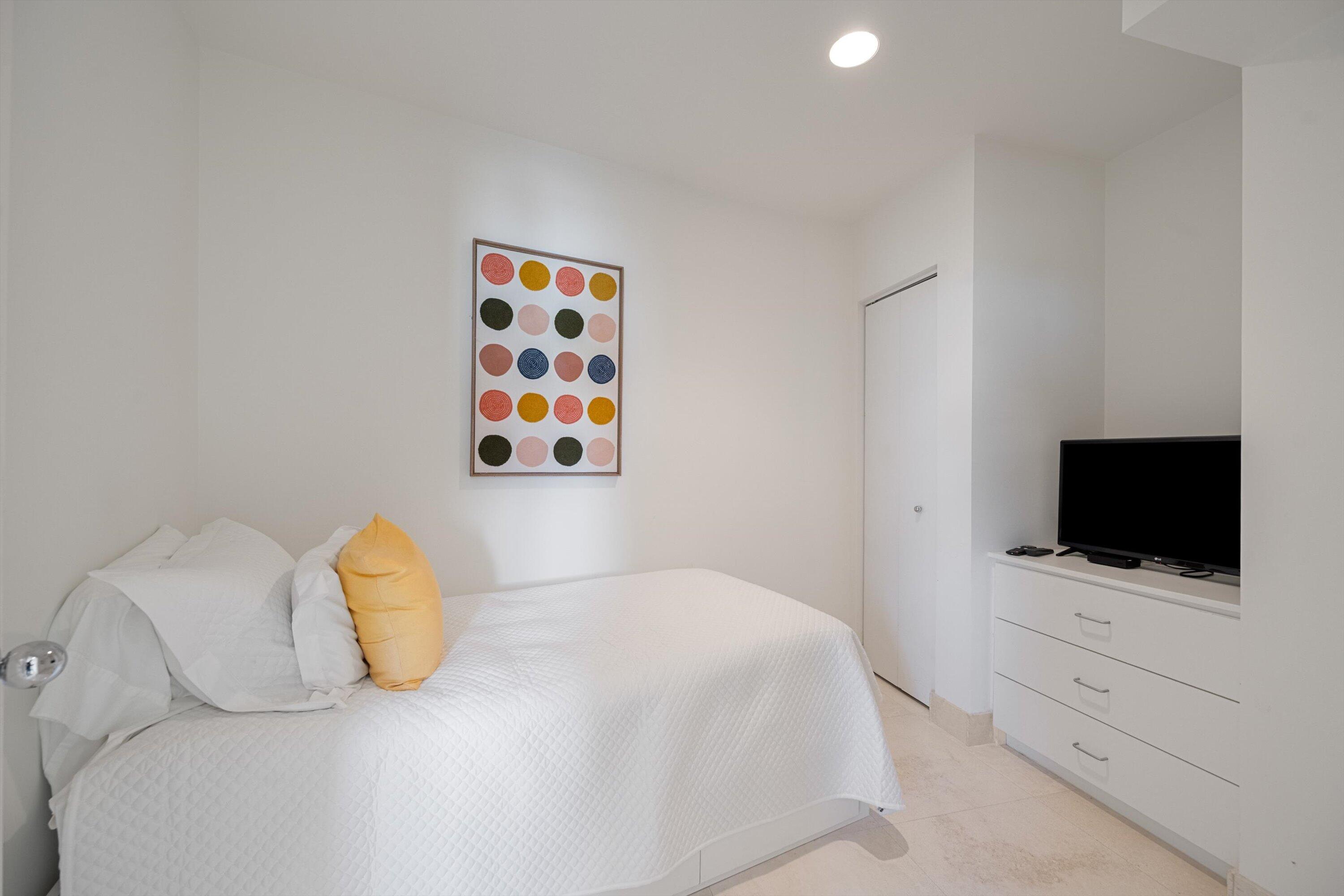 44 Cocoanut Row, Unit 514A Palm Beach, FL 33480 - Photo 18 of 34 a bedroom with a bed and a flat screen tv