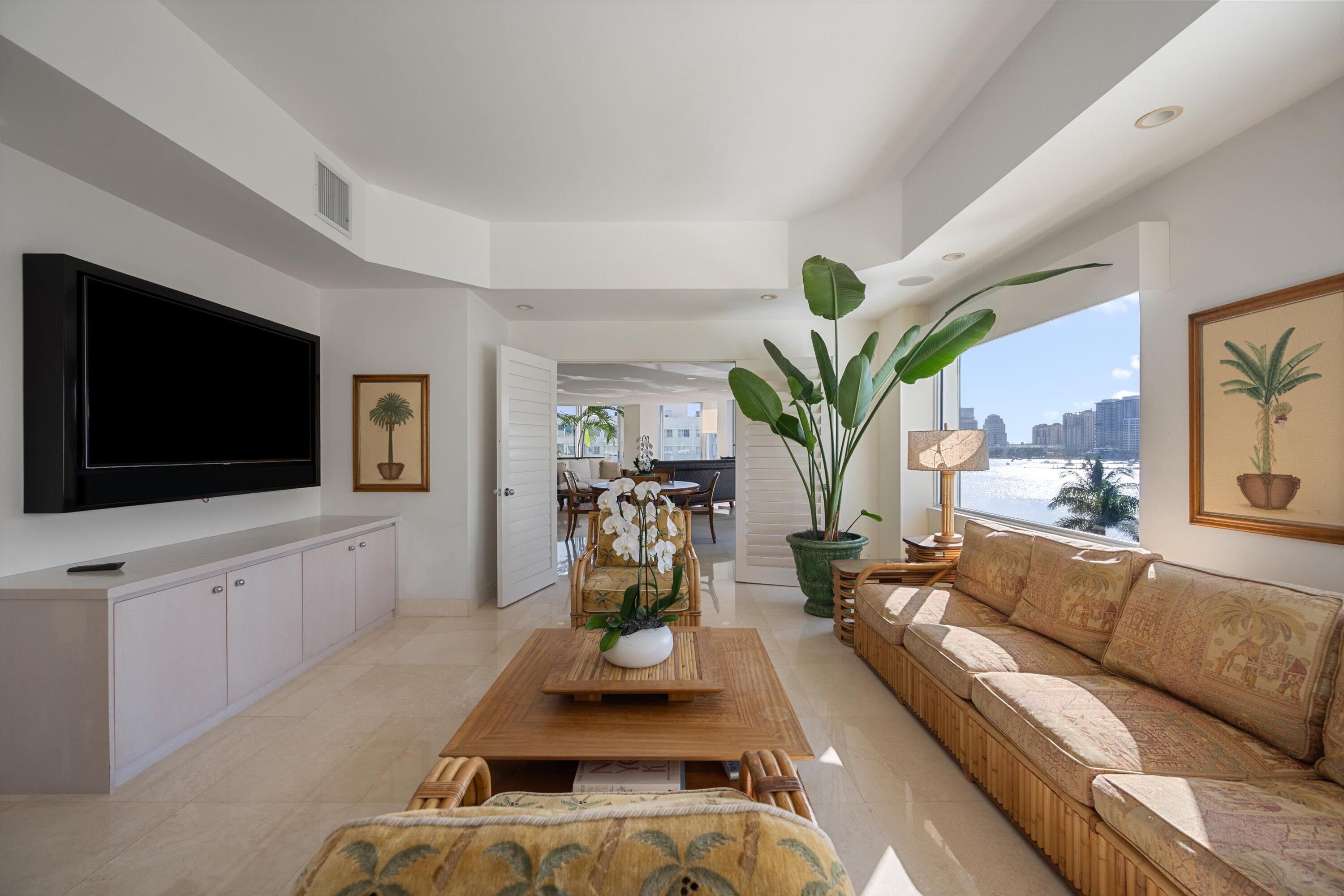 44 Cocoanut Row, Unit 514A Palm Beach, FL 33480 - Photo 9 of 34 a living room with furniture a flat screen tv and a potted plant
