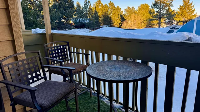 a view of a balcony with wooden chairs and floor