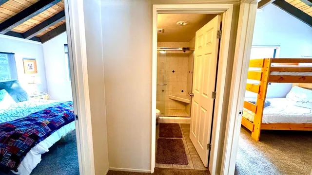 a bedroom with a bed and a mirror