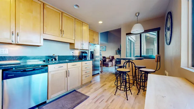 a kitchen with stainless steel appliances granite countertop a sink stove and microwave